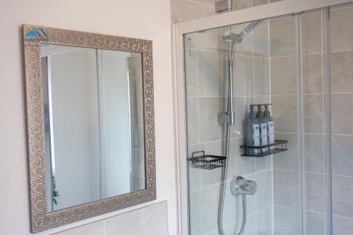 a shower with a mirror in a bathroom at Pines Villas 1, Three Spacious 3BR Homes, Perfect for Groups in Boughton