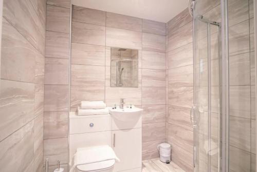 a bathroom with a toilet and a sink and a shower at Fantastic 1 Bed Central Preston Apartment in Preston