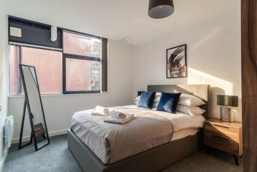 a bedroom with a bed and two windows at Fantastic 1 Bed Central Preston Apartment in Preston