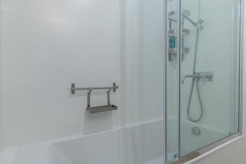 a shower in a bathroom with a glass shower stall at Lagares 74 in Lisbon