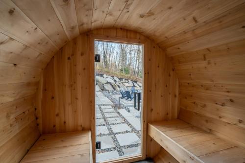 an inside view of a wooden room with a window at Lake and Pool table - The Dorchester in Saint-Prosper