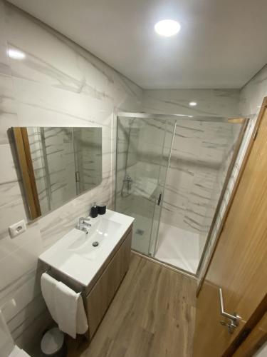 a bathroom with a toilet and a sink and a shower at Casa da Boucinha in Celorico de Basto