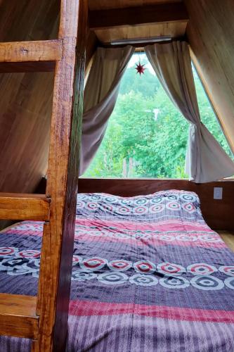 a bedroom with a bunk bed in a tent at Camping Aiton Amunak in El Bolsón