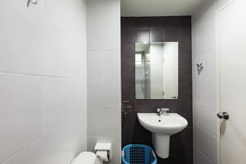 a bathroom with a sink and a toilet and a mirror at 1 bdrm condo 5 minutes walk 2 BTS Fiber optic Wifi in Bangkok