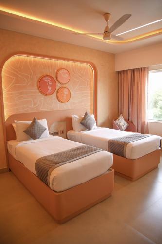 a hotel room with two beds and a window at RATHNA RESIDENCY in Coimbatore