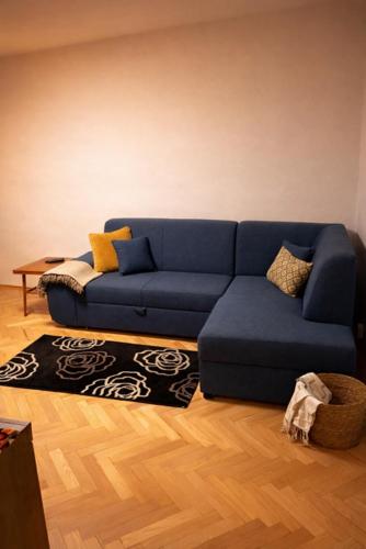 a blue couch sitting in a living room at Urban Nest in the city center in Poprad