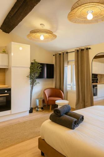 a bedroom with a bed and a living room at New - Appartement ou Studio Centre Ville Confort in Grasse