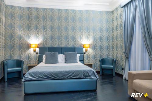 En eller flere senge i et værelse på Via Veneto Suites