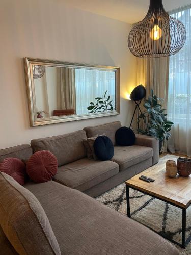 a living room with a couch and a mirror at Luxury Prinsengracht Canal House Jordan Area in Amsterdam