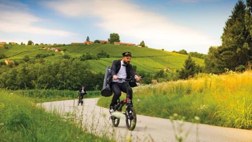 a man riding a bike down a road with another at Villa Lotus in Štrigova