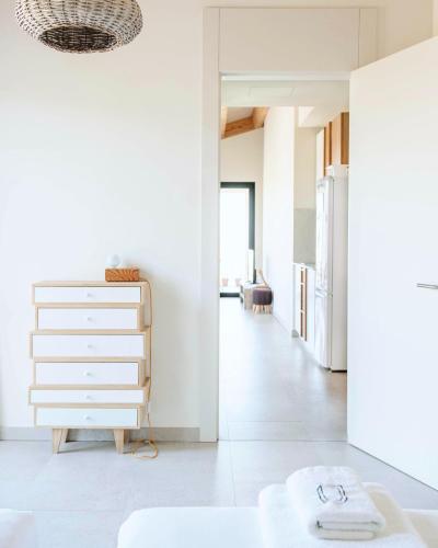 a kitchen with a white dresser and a hallway at Can Alemany in Santa Margarita de Mombúy