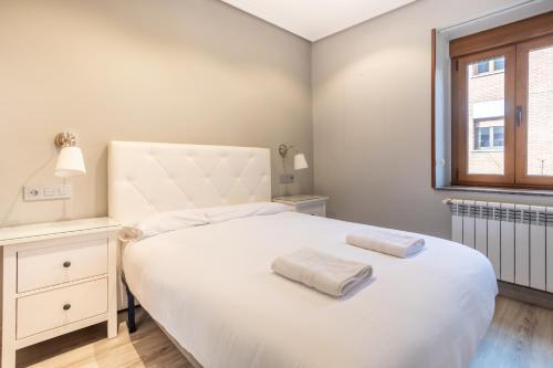 En eller flere senge i et værelse på Your Cosy Home in Figaredo