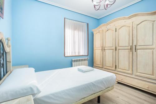 En eller flere senge i et værelse på Your Cosy Home in Figaredo