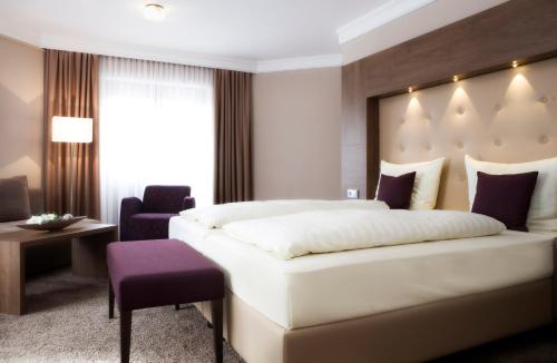 Ένα ή περισσότερα κρεβάτια σε δωμάτιο στο Ringhotel Nassau-Oranien
