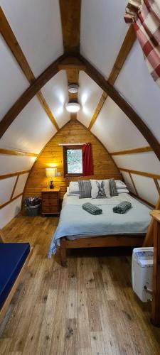 a bedroom with a large bed in a attic at Glamping Life Retreat in Nantmel