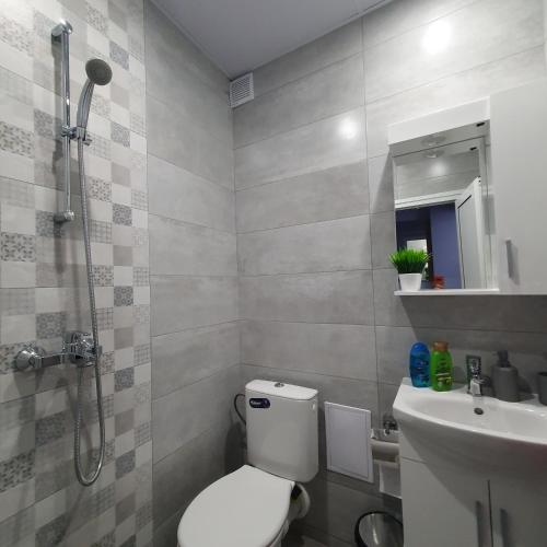 a bathroom with a toilet and a sink and a shower at Yantra Tower Studio Maya in Gabrovo