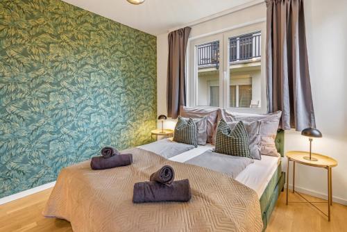 En eller flere senge i et værelse på Apartment Botanika 2