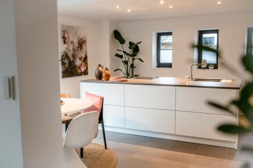 een keuken met een wastafel en een tafel bij HofZeit 1 in Mechernich