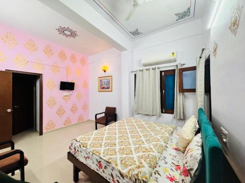 a bedroom with a bed and a tv on the wall at Hotel Lake Vista Stays in Udaipur