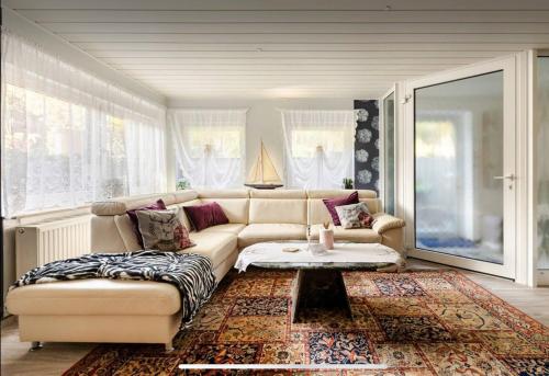 a living room with a couch and a table at Große Helle Wohnung am Wald in Bad Saarow Nahe Grünheide und Berlin Souterrain in Bad Saarow