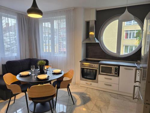 a kitchen and dining room with a table and chairs at APart Residence Shumen in Shumen