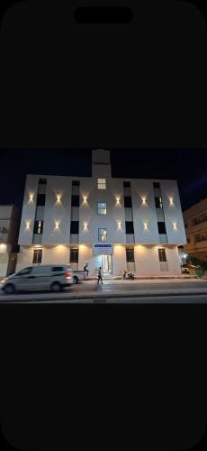 a white building with lights on the side of it at استديو مودرن فندقي in Al Kharj