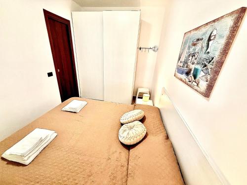 a room with a bed with two pillows on it at Pine Beach House - Villaggio Turistico con Piscina e Animazione in Campofelice di Roccella