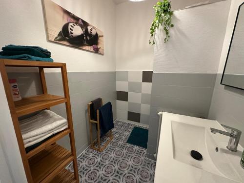 a bathroom with a sink and a mirror at Le TNB Rennes in Rennes