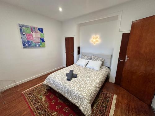 a bedroom with a bed with a cross on it at Le TNB Rennes in Rennes