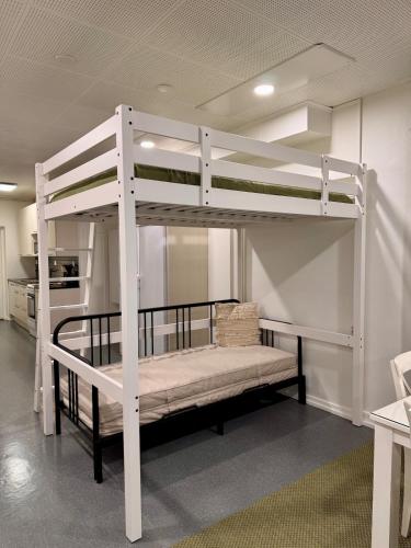 a white bunk bed in a room at Lahtihovi in Lahti