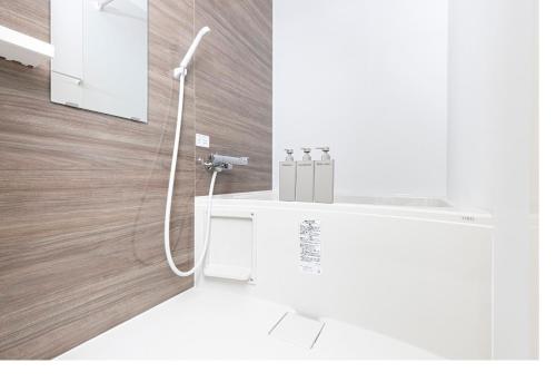 a white bathroom with a shower with a sink at ぷふかTK東向島1F -1min to Higashi Mukojima Sta 1F Cozy Stay Near Skytree Asakusa in Tokyo