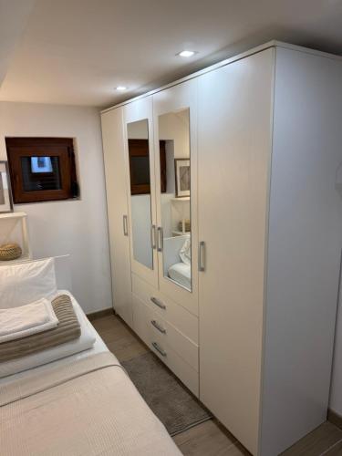a bedroom with a white cabinet and a bed at Noel in Vukovar