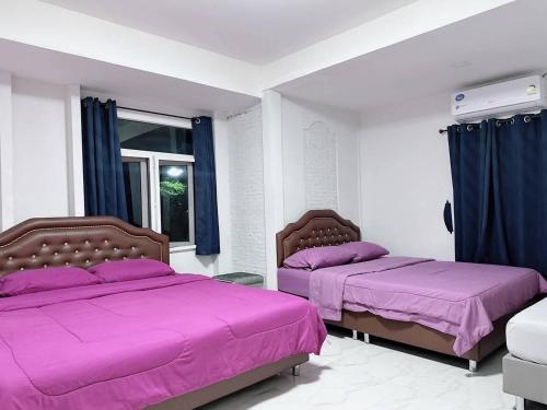 En eller flere senge i et værelse på พิฑารัตน์รีสอร์ท