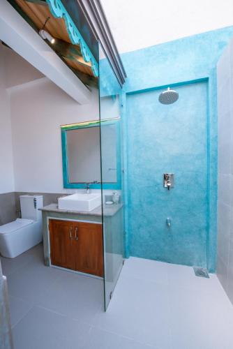 a bathroom with a blue door and a sink at Sithagi River Front Villa Weligama in Weligama