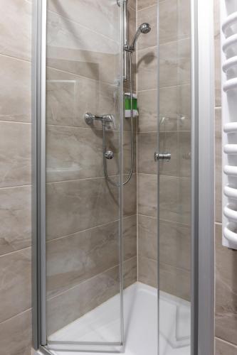 a shower with a glass door in a bathroom at Ubytováni u PÁji in Kynšperk nad Ohří