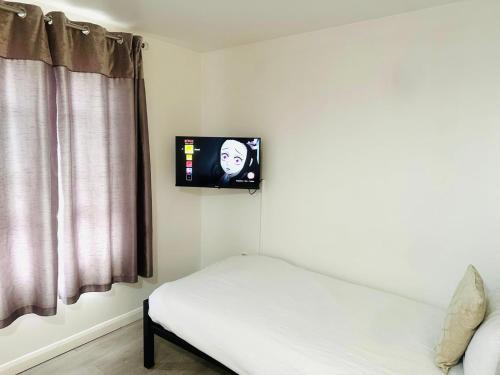 a room with a bed and a tv on the wall at Westferry in London