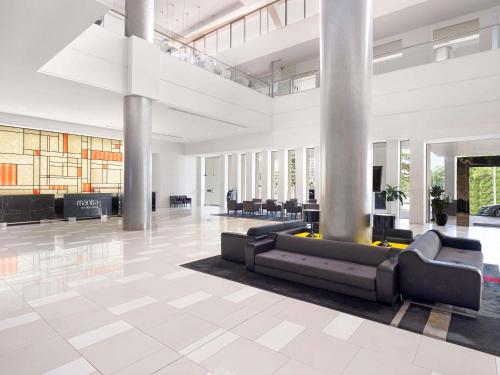 a lobby with couches and tables in a building at Mantra on View in Gold Coast