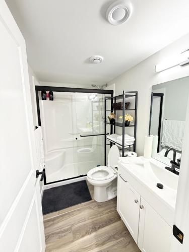 a bathroom with a shower and a toilet and a sink at 2-Bed Cozy Nest in Winnipeg