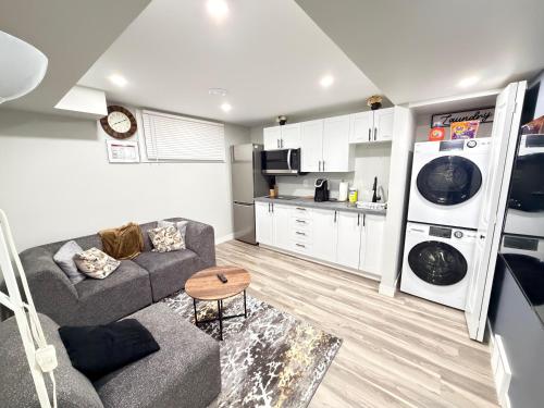 een woonkamer met een bank en een keuken bij 2-Bed Cozy Nest in Winnipeg