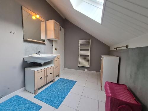 a bathroom with a sink and a mirror and a sink at Maison d'Hôtes de Belleville in Belleville