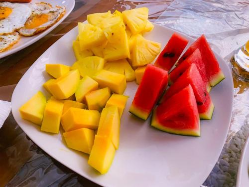 a white plate with fruit on a table at Rich Hill Garden in Galle