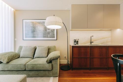 a living room with a couch and a kitchen at Gran Cruz Apartments in Vila Nova de Gaia