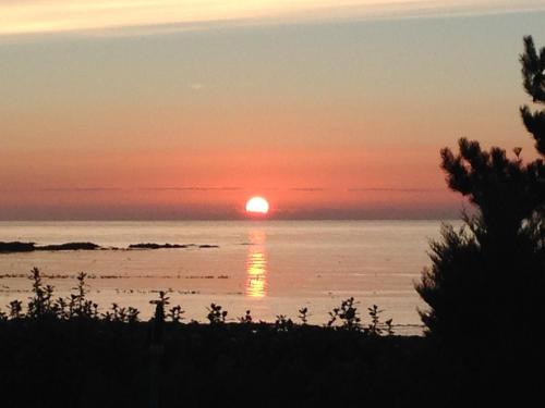 a sunset over the ocean with the sun reflecting in the water at Gowan Bank in Gourdon