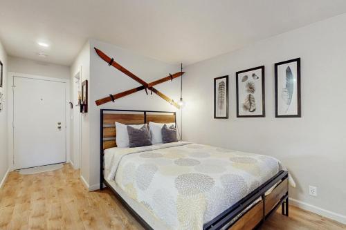 a bedroom with a large bed and some pictures on the wall at Cozy Kings Run Condo in Kingswood Estates