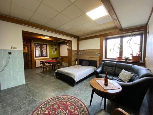 a living room with a bed and a couch at Studio JAVOR pod Tatrami in Jezersko