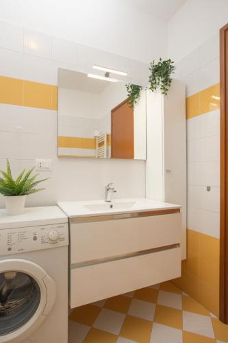 a bathroom with a sink and a washing machine at ArtStay Apt near Rho Fiera, Pool, Parking in Settimo Milanese