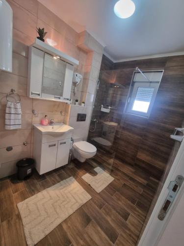 a bathroom with a toilet and a sink and a shower at Apartman Best Zlatar in Ciganska Mahala