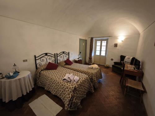 a bedroom with a large bed and a table at Cascina Montalbano in Rosignano Monferrato