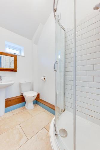 a bathroom with a shower and a toilet and a sink at 1 Bed in Duloe oc-l30057 in Duloe