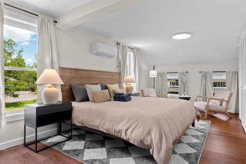 a bedroom with a large bed with two lamps at NEW HOT TUB Game Room Firepit Near Windham in Prattsville